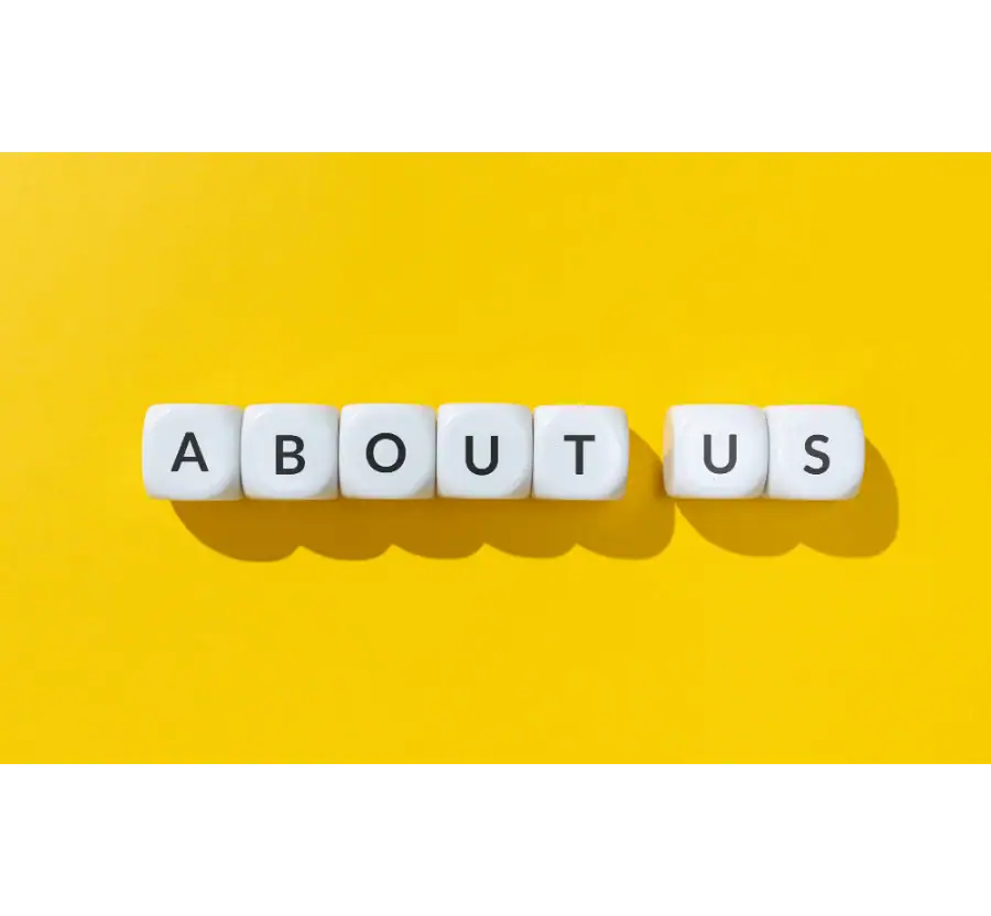 Letter blocks spelling About Us on a yellow background